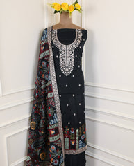 Black embroidered dress with a colorful dupatta on a white background