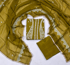 Green fabric with white embroidery on a white background