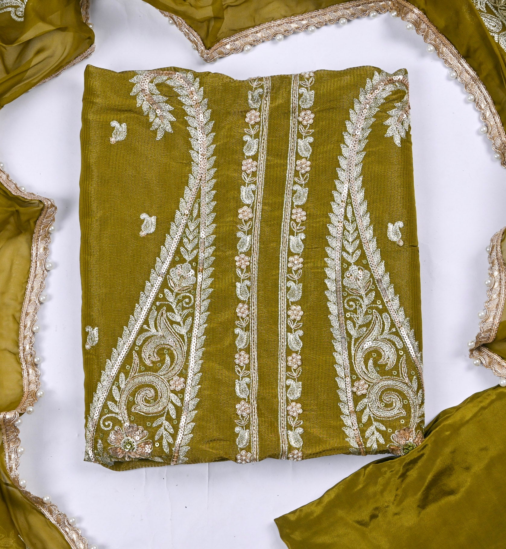 Green fabric with white embroidery on a white background