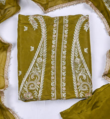 Green fabric with white embroidery on a white background