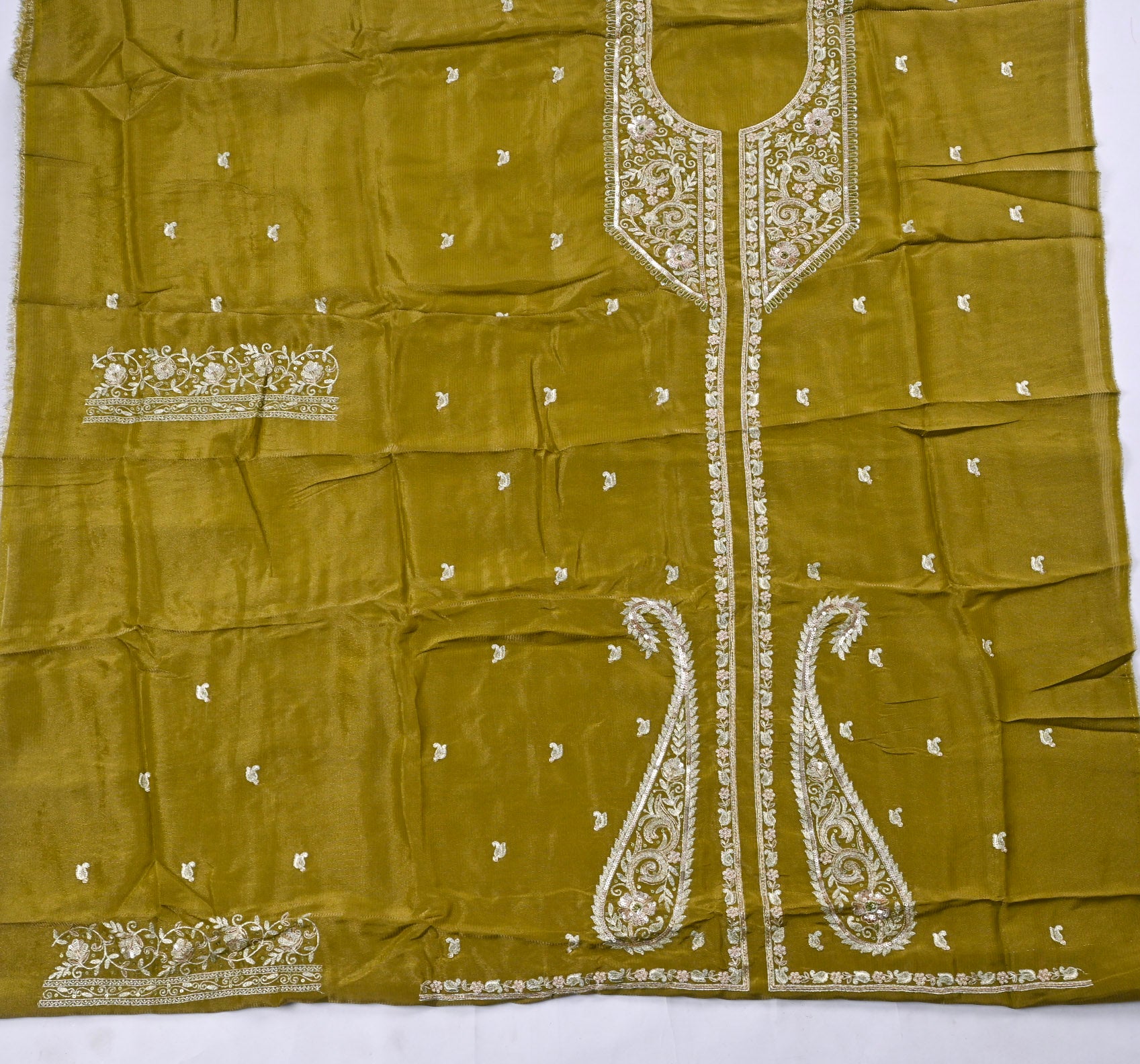 Green fabric with white embroidery on a white background