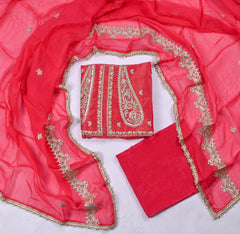 Red fabric with gold embroidery on a white background