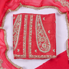 Red fabric with gold embroidery on a white background