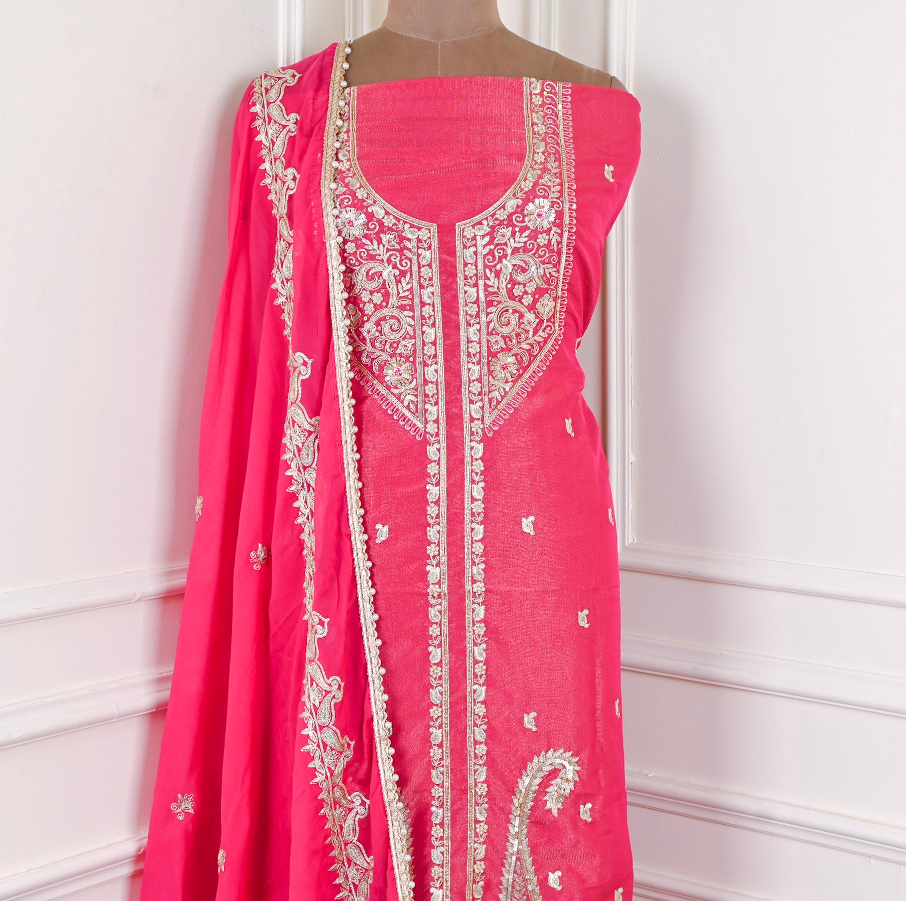 Pink embroidered dress with matching dupatta on a mannequin against a white background
